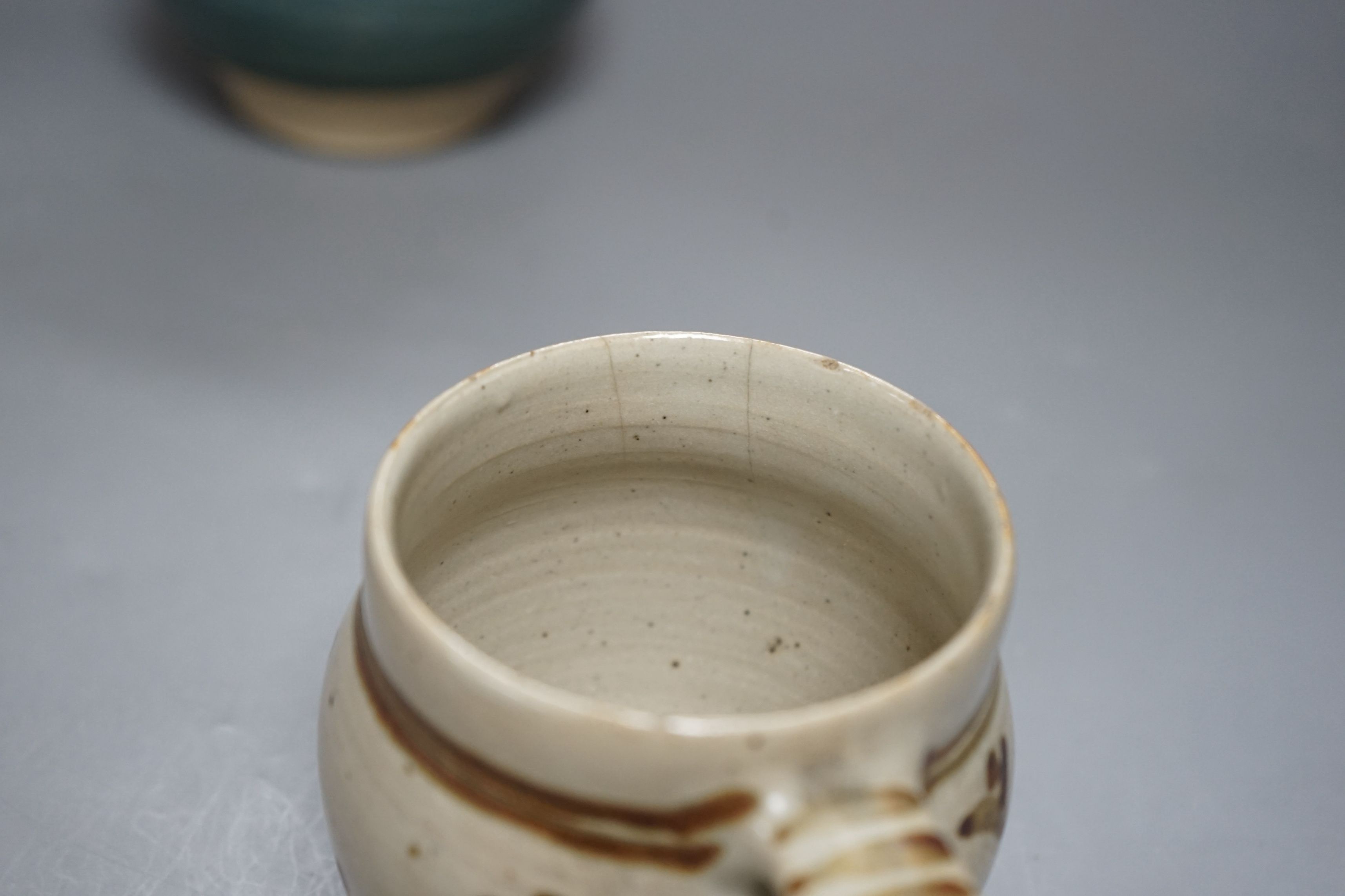 An Accolay style blue glazed stripe vase, together with a Wenford Bridge stoneware mug, both with impressed marks, tallest 19cm, (2)